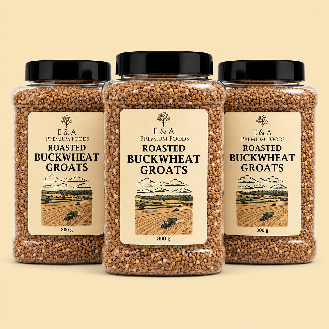 Three clear plastic jars of E&A Premium Foods Roasted Buckwheat Groats with black lids, arranged symmetrically on a light beige background.